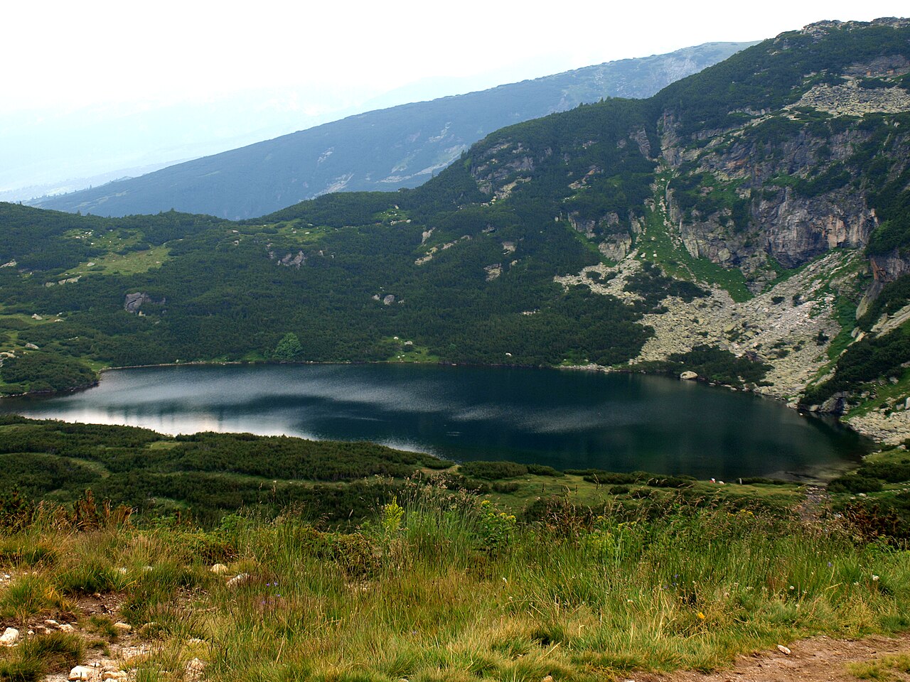 Glacial lakes among rocky ridges and grass in the Rila mountains of Bulgaria