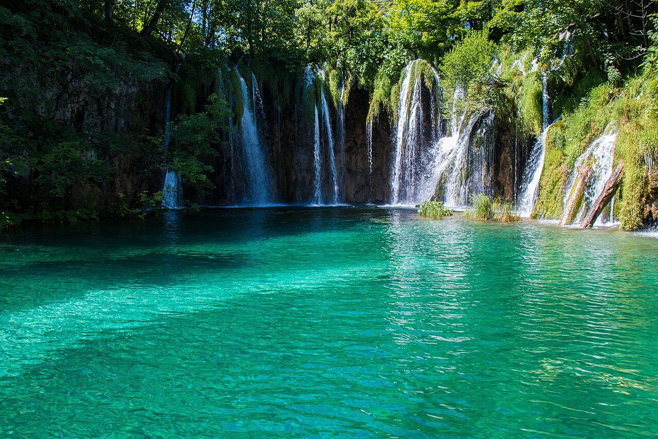 Turquoise lakes and waterfalls among trees in Plitvice Lakes National Park