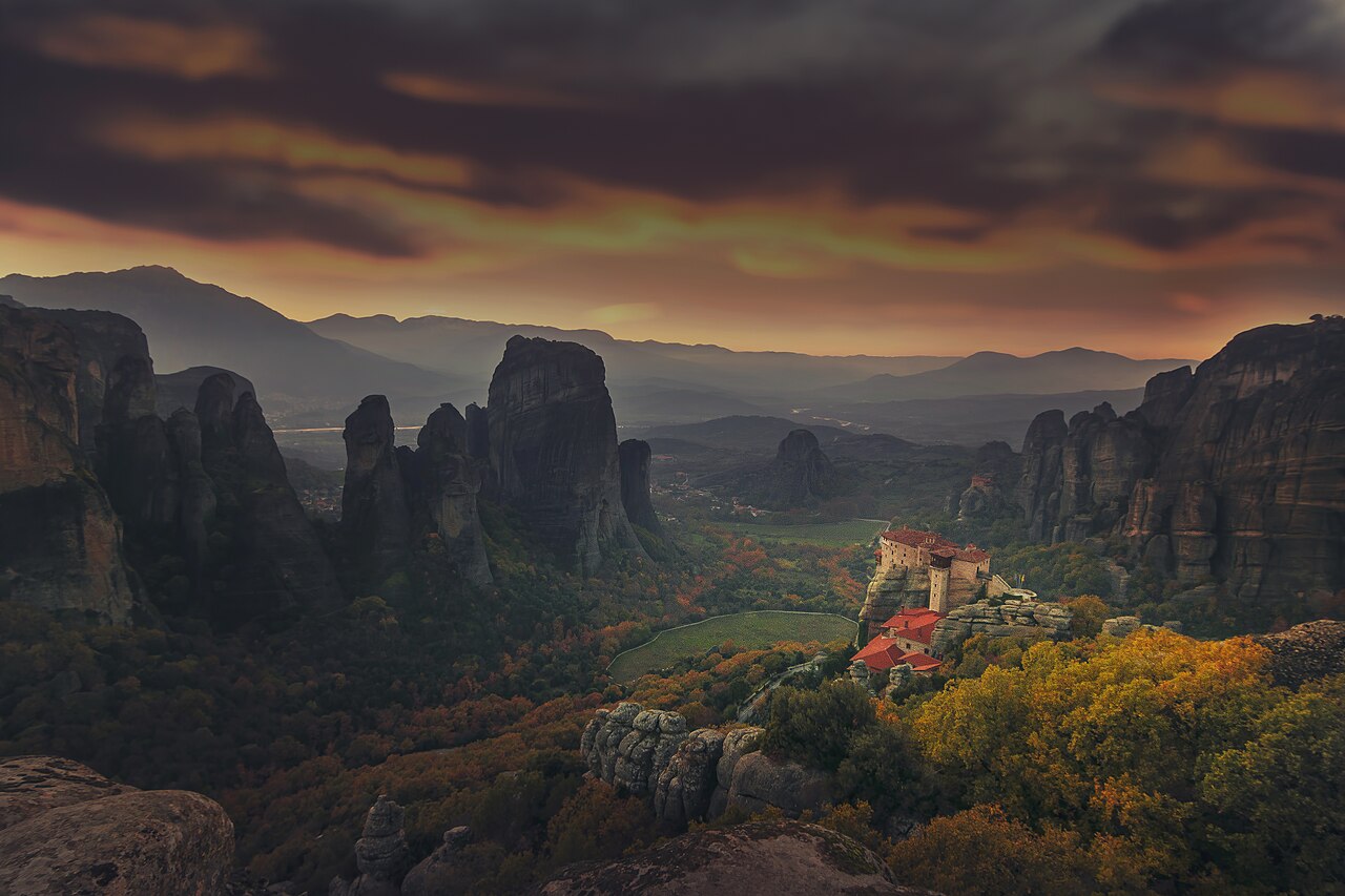 The rock pillars of Meteora rising from a valley in central Greece, with a monastery on top of one