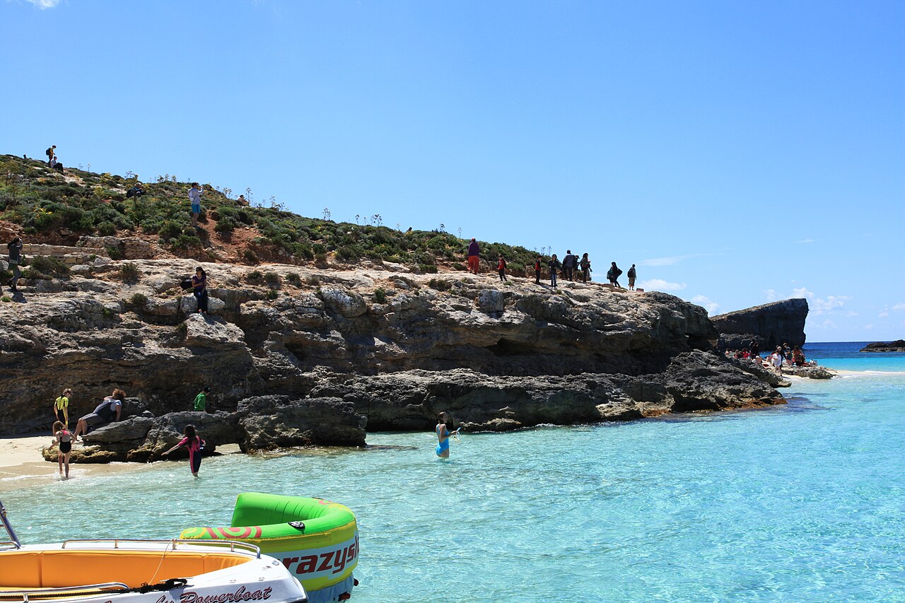The shallow turquoise water of the Blue Lagoon beside the small island of Comino in Malta