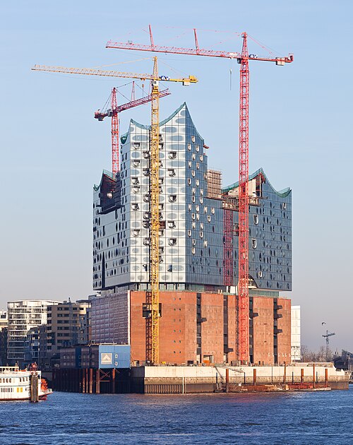 The Elbphilharmonie concert hall in Hamburg rising from a brick warehouse beside the harbor
