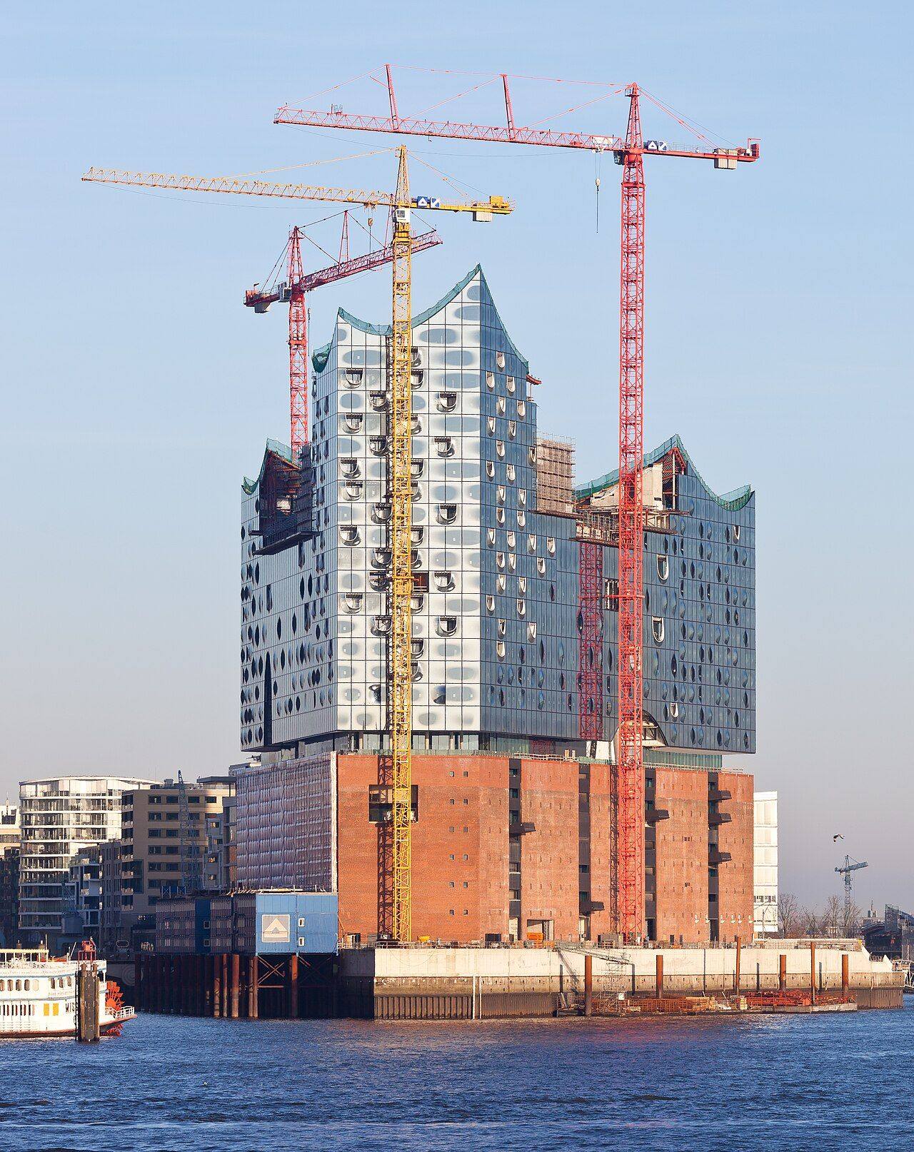 The Elbphilharmonie concert hall in Hamburg rising from a brick warehouse beside the harbor