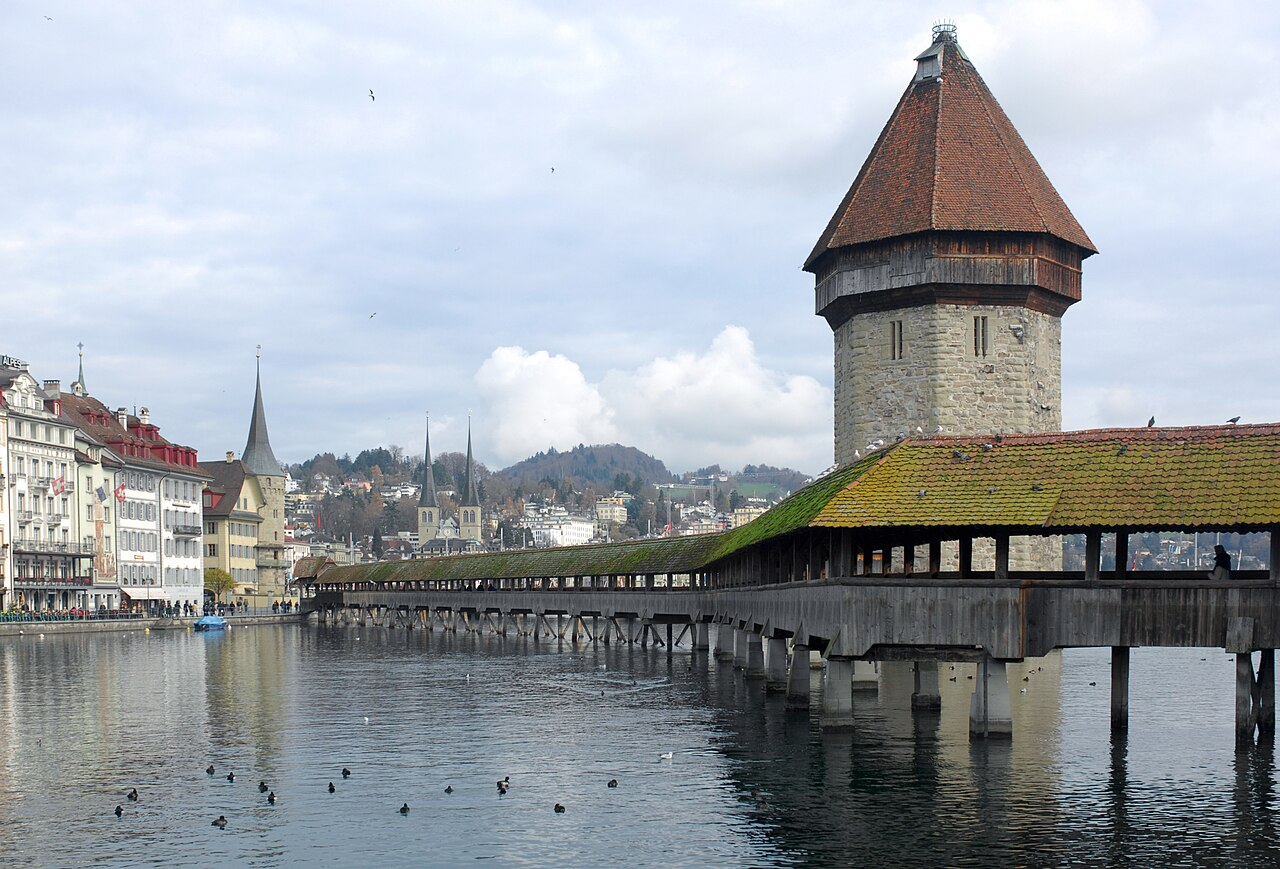 The covered wooden Chapel Bridge and its water tower across the river in Lucerne