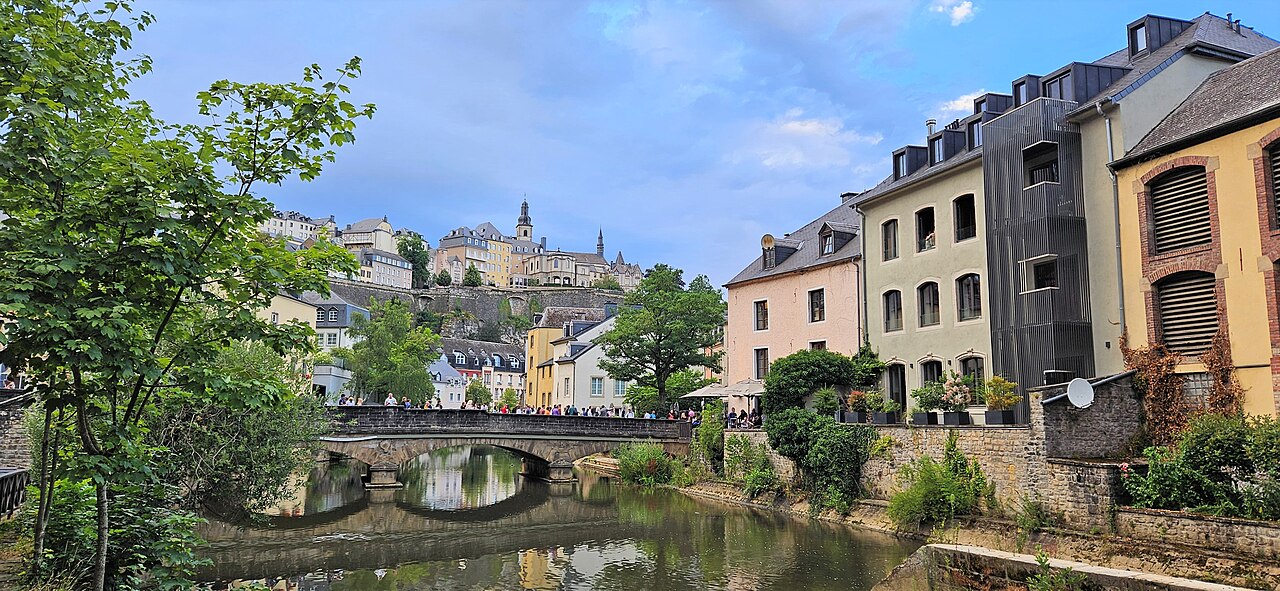 A wide view of the Grund quarter of Luxembourg City, with the Alzette river winding below the old fortress walls