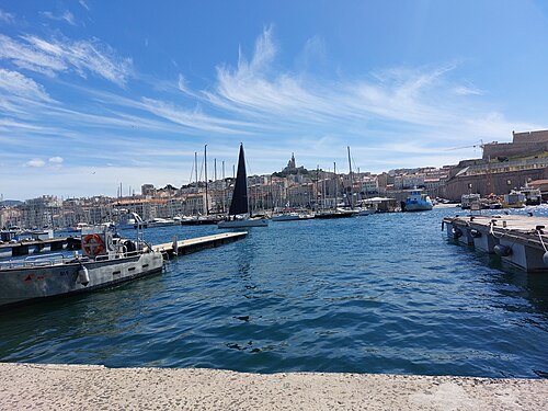 Boats moored in the Vieux-Port of Marseille with Notre-Dame de la Garde on the hill behind