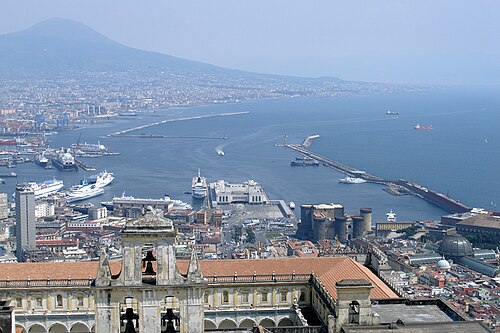 A view over the Bay of Naples and the port, with Mount Vesuvius rising in the distance