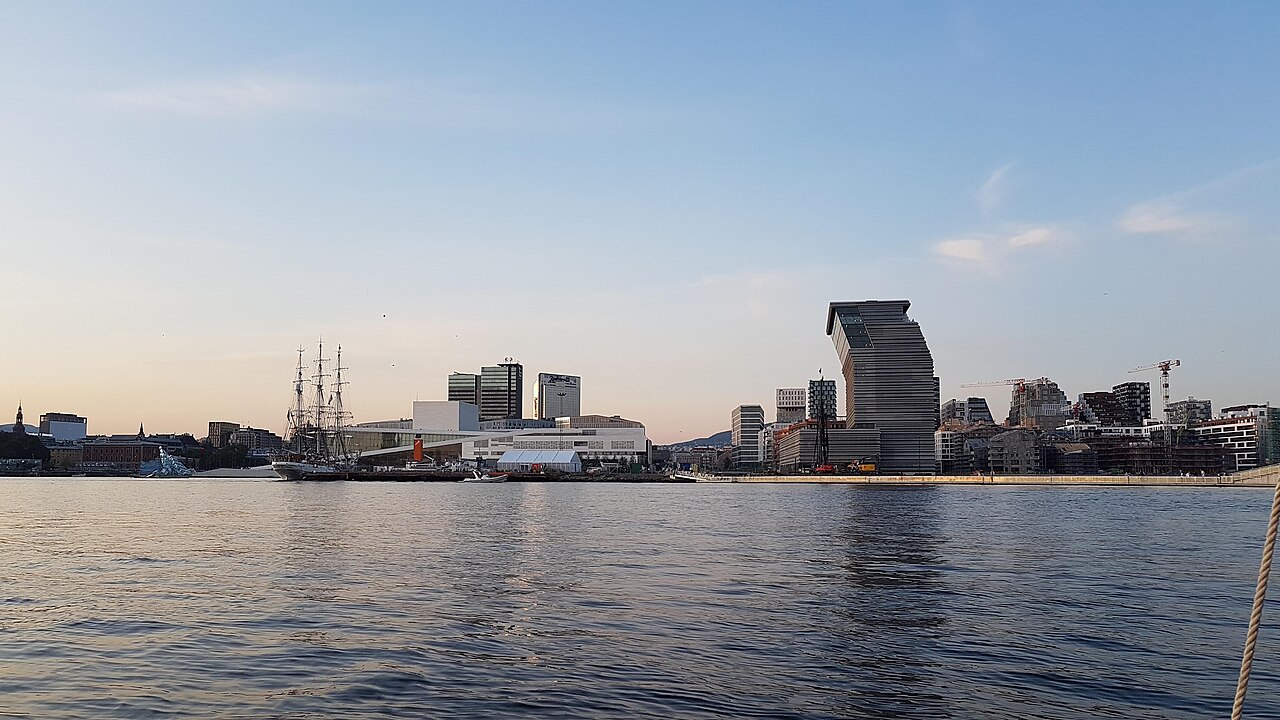Oslo seen from the fjord, with the white Opera House and the waterfront buildings of Bjørvika behind it